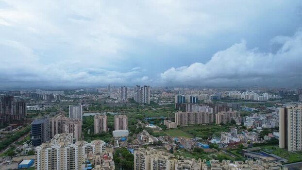 Aerial view of Gurugram skyscrapers and monsoon clouds India.