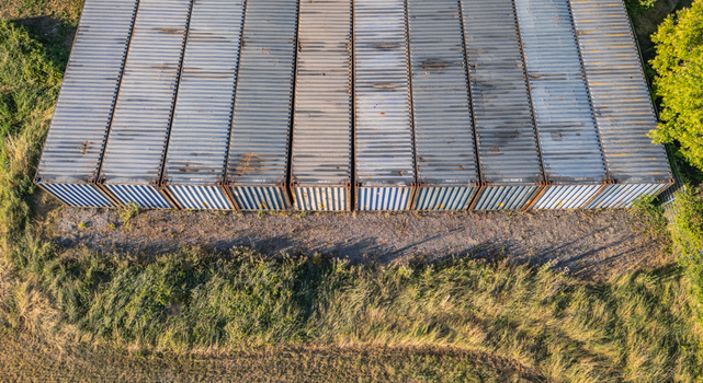 Aerial view of rows of stacked shipping containers at an industrial site Le Pouzin Auvergne Rhone Alpes France.