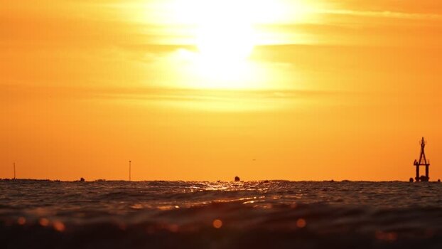 View of a buoy and sun over the sea France. View of a buoy and sun over the sea France.