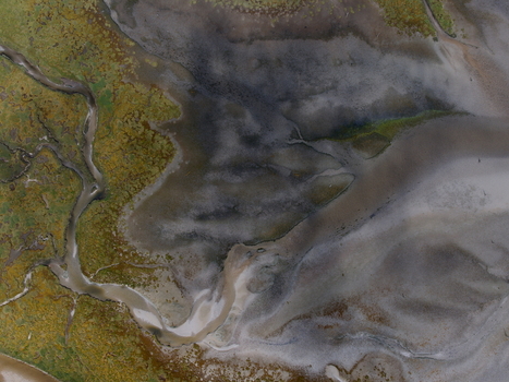 Aerial view of abstract tidal patterns at Culbin Sands with intricate channels and textures in the mudflats near Nairn Scotland United Kingdom. Aerial view of abstract tidal patterns at Culbin Sands with intricate channels and textures in the mudflats near Nairn Scotland United Kingdom.