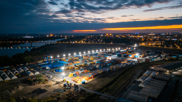 Aerial view of RTC Luka Leget port terminal with rows of shipping containers illuminated at night along the Sava River in Sremska Mitrovica Vojvodina Serbia. Aerial view of RTC Luka Leget port terminal with rows of shipping containers illuminated at night along the Sava River in Sremska Mitrovica Vojvodina Serbia.
