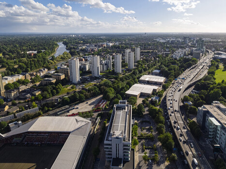 Aerial view of the Gtech Community Stadium and surrounding residential high rise buildings urban infrastructure and the River Thames in Brentford England United Kingdom. Aerial view of the Gtech Community Stadium and surrounding residential high rise buildings urban infrastructure and the River Thames in Brentford England United Kingdom.