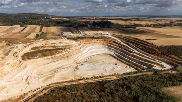 Aerial view of the open pit mine with terraced slopes and surrounding agricultural fields in Besenovo Vojvodina Serbia. Aerial view of the open pit mine with terraced slopes and surrounding agricultural fields in Besenovo Vojvodina Serbia.
