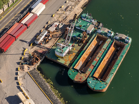 Aerial view of Rio Ozama with industrial barges and shipping containers docked at the port in Santo Domingo Santo Domingo Dominican Republic.