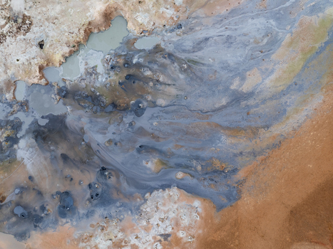 Aerial view of the Hverir geothermal area featuring bubbling mud pools steaming vents and vibrant mineral deposits across the volcanic landscape Reykjahlid Thingeyjarsveit Iceland. Aerial view of the Hverir geothermal area featuring bubbling mud pools steaming vents and vibrant mineral deposits across the volcanic landscape Reykjahlid Thingeyjarsveit Iceland.