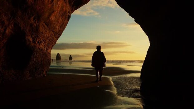 View of the Three Sisters and a person exiting a cave New Zealand. View of the Three Sisters and a person exiting a cave New Zealand.