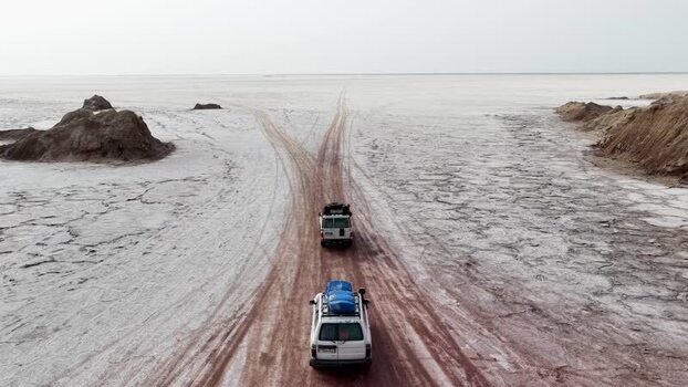 Aerial view of off road vehicles driving through the Danakil Desert Ethiopia. Aerial view of off road vehicles driving through the Danakil Desert Ethiopia.
