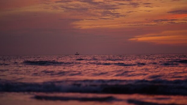 View of a small boat on the horizon at sunset Bangladesh. View of a small boat on the horizon at sunset Bangladesh.