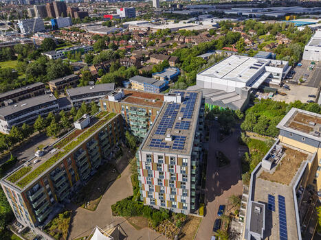Aerial view of modern apartment buildings featuring green roofs and solar panels in a residential neighborhood in London England United Kingdom. Aerial view of modern apartment buildings featuring green roofs and solar panels in a residential neighborhood in London England United Kingdom.