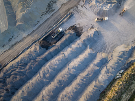 Aerial view of dump trucks transporting gravel and sand at a large industrial quarry site in Istanbul Istanbul Turkiye.
