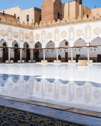 View of Al Azhar Mosque courtyard with its polished white marble floor reflecting the elegant arches and intricate stone carvings Cairo Egypt. View of Al Azhar Mosque courtyard with its polished white marble floor reflecting the elegant arches and intricate stone carvings Cairo Egypt.
