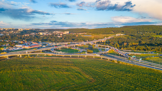 Aerial view of Lahovice Bridge and the surrounding highway interchange at sunset with green fields and rolling hills in the background Prague Prague Czechia. Aerial view of Lahovice Bridge and the surrounding highway interchange at sunset with green fields and rolling hills in the background Prague Prague Czechia.