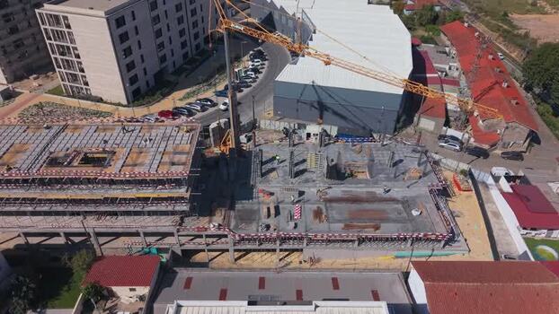 Aerial view of construction site with yellow crane in Barcelos Portugal.
