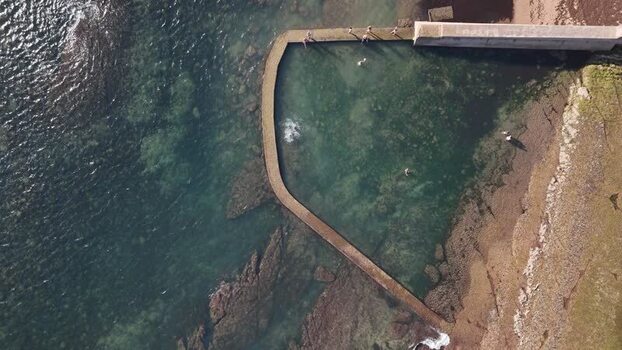 Aerial view of Praia das Avencas rock pool in Portugal.