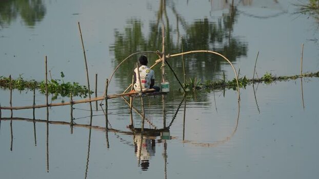 View of a fisherman on a bamboo platform Bangladesh.