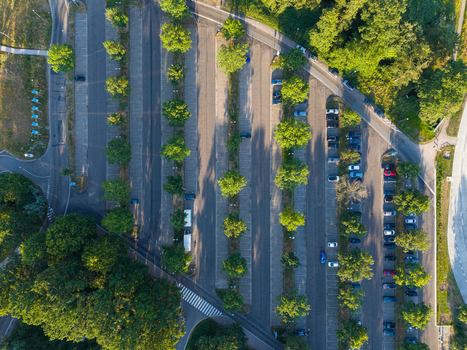 Aerial view of the parking lot at Universiteit Hasselt with rows of parked cars and surrounding green trees in Diepenbeek Vlaanderen Belgium. Aerial view of the parking lot at Universiteit Hasselt with rows of parked cars and surrounding green trees in Diepenbeek Vlaanderen Belgium.
