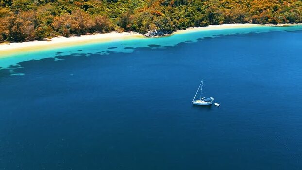 Aerial view of a sailboat anchored in turquoise waters Honduras. Aerial view of a sailboat anchored in turquoise waters Honduras.