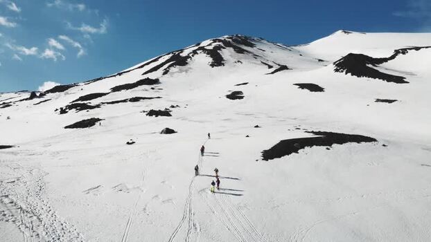 Aerial view of skiers on the snowy slopes of Rifugio Sapienza Italy. Aerial view of skiers on the snowy slopes of Rifugio Sapienza Italy.