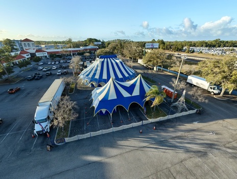 Aerial view of the blue and white striped circus tents standing tall against the backdrop of the surrounding urban landscape St. Augustine Florida United States. Aerial view of the blue and white striped circus tents standing tall against the backdrop of the surrounding urban landscape St. Augustine Florida United States.