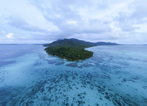 Aerial view of the lush green island surrounded by turquoise waters Tanjung Gelam Beach Karimunjawa Central Java Indonesia. Aerial view of the lush green island surrounded by turquoise waters Tanjung Gelam Beach Karimunjawa Central Java Indonesia.