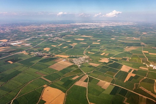 Aerial view of agricultural fields and a small village surrounded by patchwork farmland in Adana Adana Turkey. Aerial view of agricultural fields and a small village surrounded by patchwork farmland in Adana Adana Turkey.