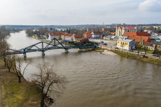 Kedainiai Lithuania 17 March 2026 Aerial view of the historic old town with the blue pedestrian bridge crossing the Nevezis River under an overcast sky. Kedainiai Lithuania 17 March 2026 Aerial view of the historic old town with the blue pedestrian bridge crossing the Nevezis River under an overcast sky.