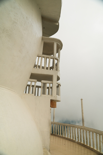 View of the white spiral staircase and balconies of Ambuluwawa Tower enveloped in thick morning mist Gampola Central Province Sri Lanka. View of the white spiral staircase and balconies of Ambuluwawa Tower enveloped in thick morning mist Gampola Central Province Sri Lanka.
