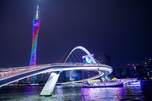 Guangzhou China 24 February 2024 View of the illuminated Canton Tower and Liede Bridge reflecting over the Pearl River at night. Guangzhou China 24 February 2024 View of the illuminated Canton Tower and Liede Bridge reflecting over the Pearl River at night.
