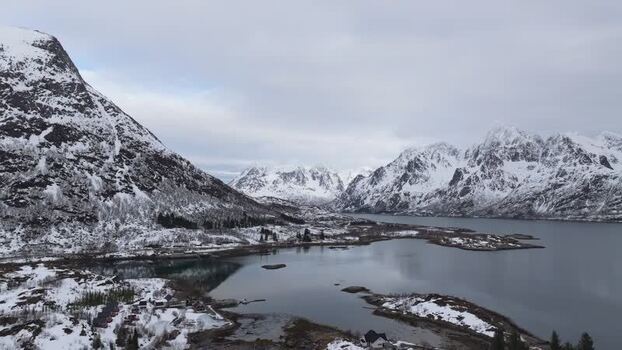 Aerial view of snowy Lofoten mountains and fjord Norway.