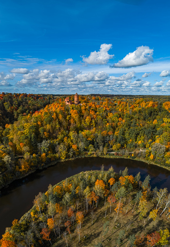 Aerial view of Turaida Castle surrounded by vibrant autumn forest and the Gauja River in Sigulda Sigulda Municipality Latvia. Aerial view of Turaida Castle surrounded by vibrant autumn forest and the Gauja River in Sigulda Sigulda Municipality Latvia.
