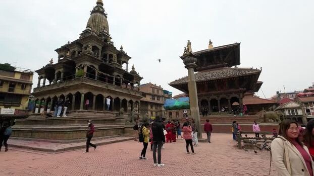 View of Patan Durbar Square temples with people walking Nepal.