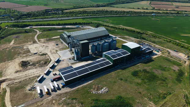 Aerial view of the Oat Milling Factory featuring large silos solar panels on rooftops and trucks parked in the loading area Kettering England United Kingdom. Aerial view of the Oat Milling Factory featuring large silos solar panels on rooftops and trucks parked in the loading area Kettering England United Kingdom.