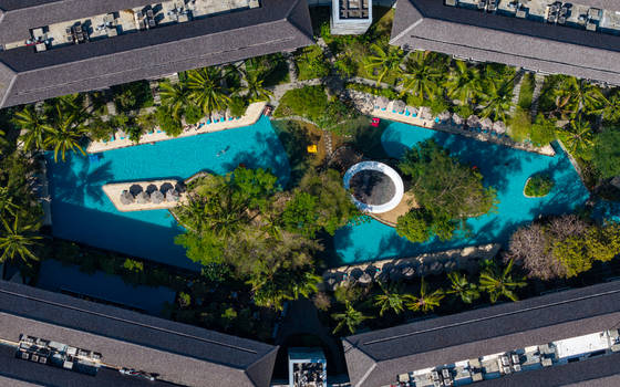 Aerial view of Marriott s Bali Nusa Dua Gardens featuring turquoise swimming pools surrounded by lush tropical gardens and resort buildings in Kecamatan Kuta Selatan Bali Indonesia.