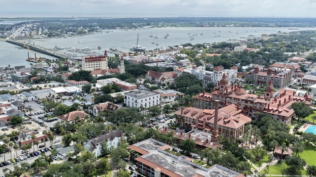 Aerial view of the historic district featuring the architecture of Flagler College and the Hotel Ponce de Leon surrounded by trees and streets in St. Augustine Florida United States. Aerial view of the historic district featuring the architecture of Flagler College and the Hotel Ponce de Leon surrounded by trees and streets in St. Augustine Florida United States.