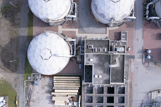 Aerial view of the Lulu Island Wastewater Treatment Plant featuring large white geodesic dome digesters industrial infrastructure and water treatment tanks in Richmond British Columbia Canada. Aerial view of the Lulu Island Wastewater Treatment Plant featuring large white geodesic dome digesters industrial infrastructure and water treatment tanks in Richmond British Columbia Canada.