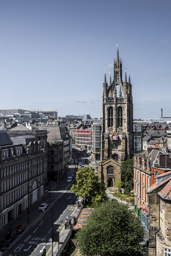 Aerial view of St. Nicholas Cathedral surrounded by historic stone buildings and urban streets in Newcastle upon Tyne England United Kingdom. Aerial view of St. Nicholas Cathedral surrounded by historic stone buildings and urban streets in Newcastle upon Tyne England United Kingdom.
