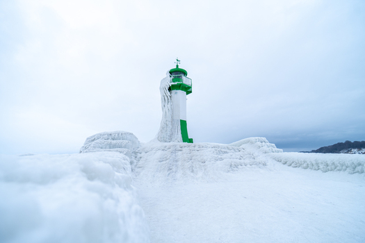 View of the frozen Molenfeuer Sassnitz lighthouse covered in thick ice during a cold winter day in Sassnitz Mecklenburg Vorpommern Germany.