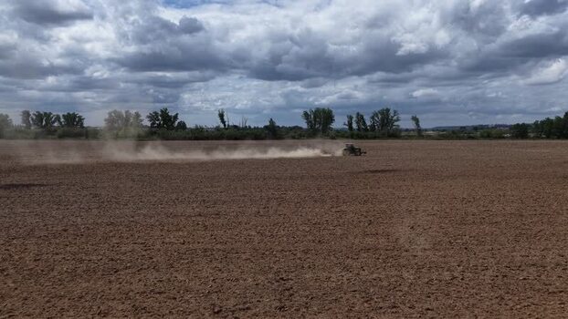 Aerial view of a tractor working in a tilled field Portugal. Aerial view of a tractor working in a tilled field Portugal.