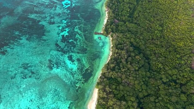 Aerial view of Praslin Ferry Harbour and coral reefs Seychelles.