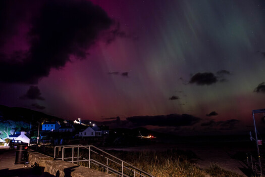 View of the Aurora Borealis illuminating the night sky over the coastal village of Portnoo County Donegal Ireland. View of the Aurora Borealis illuminating the night sky over the coastal village of Portnoo County Donegal Ireland.