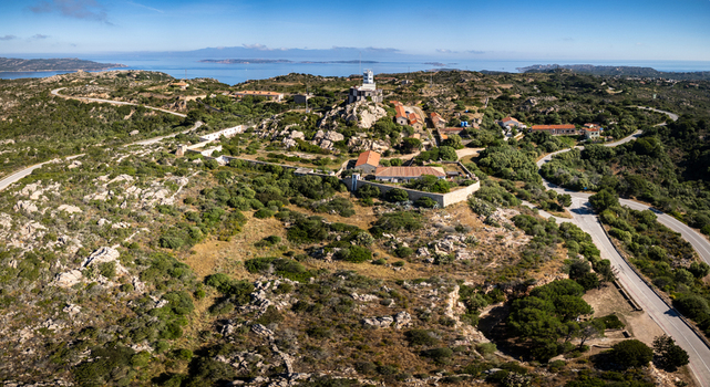 Aerial view of the Torre di Guardia Vecchia historic tower and surrounding rocky landscape with Mediterranean scrub and winding roads La Maddalena Sardinia Italy. Aerial view of the Torre di Guardia Vecchia historic tower and surrounding rocky landscape with Mediterranean scrub and winding roads La Maddalena Sardinia Italy.
