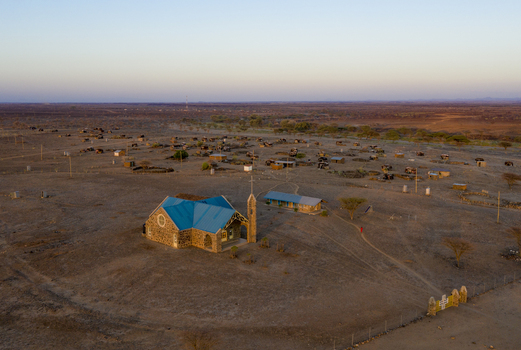 Aerial view of a church with a blue roof situated in the arid landscape of Marsabit Marsabit County Kenya. Aerial view of a church with a blue roof situated in the arid landscape of Marsabit Marsabit County Kenya.