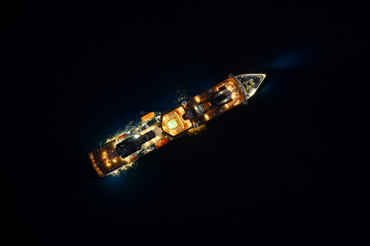 Aerial view of a cruise ship illuminated at night on the dark sea in Eze Provence Alpes Cote d Azur France. Aerial view of a cruise ship illuminated at night on the dark sea in Eze Provence Alpes Cote d Azur France.