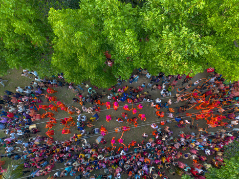 Munshiganj Bangladesh 13 April 2026 Aerial view of a vibrant colorful crowd celebrating under a lush green tree canopy a vivid scene of human joy.