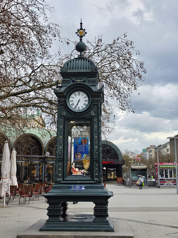 Hanover Lower Saxony Germany 29 March 2026 View of the historic Kropcke clock in the city center featuring intricate metalwork and a glass display case under a cloudy sky.