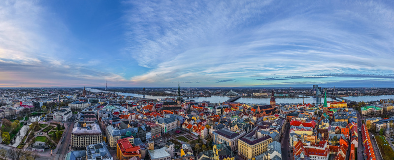 Aerial view of the historic Old Town of Riga with its iconic church spires colorful rooftops and the Daugava River flowing through the city in Riga Latvia. Aerial view of the historic Old Town of Riga with its iconic church spires colorful rooftops and the Daugava River flowing through the city in Riga Latvia.