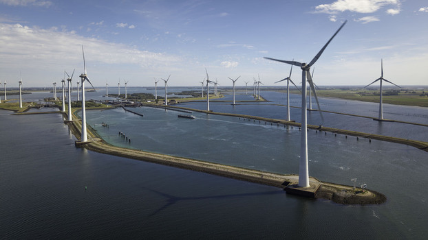 Aerial view of the Grevelingendam wind farm with rows of wind turbines standing in the water along the dam in Bruinisse Zeeland Netherlands. Aerial view of the Grevelingendam wind farm with rows of wind turbines standing in the water along the dam in Bruinisse Zeeland Netherlands.