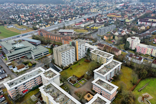 Aerial view of modern apartment buildings and residential neighborhoods with streets and green spaces in Forchheim Bavaria Germany.