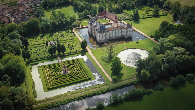 Aerial view of Chateau de Cormatin with its moat geometric formal gardens and a hedge maze Cormatin Bourgogne Franche Comte France. Aerial view of Chateau de Cormatin with its moat geometric formal gardens and a hedge maze Cormatin Bourgogne Franche Comte France.
