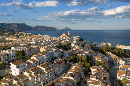 Aerial view of the historic town of Altea with its iconic blue domed church white washed buildings and Mediterranean coastline in Altea Valencian Community Spain.